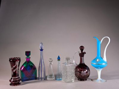 a lot of glass bottles and vases on the table