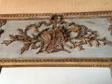 a mirror that has a picture of a bird and leaves on it