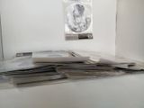 a stack of newspapers sitting on top of a counter