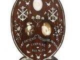 a wooden plaque with a picture of a man and a woman on it