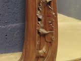 a mirror that has a wooden frame with birds on it
