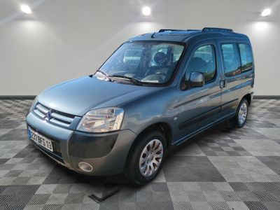 a picture of a blue van parked in a garage