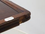 a close up of a wooden table with a name tag on it