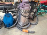 a blue vacuum and a purple vacuum on the floor