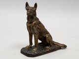 an image of a bronze statue of a dog sitting on top of a base