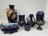 many vases and bowls that are sitting on a table