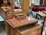 a wooden dresser with a mirror on top of it