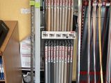 a rack of baseball bats and baseball bats in a store