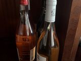 two bottles of wine sitting on a table next to each other