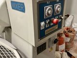 a machine that is sitting on the floor next to a pile of trash