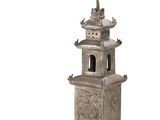 an image of a silver statue of a pagoda with a bird on top of it