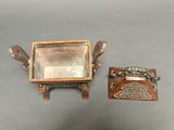 two pieces of silver and wood on the table