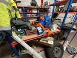 a man that is standing next to a cart with tools on it