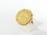 a close up of a gold coin on a white surface