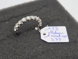a ring with a tag attached to it on a piece of cloth