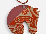 a picture of a necklace with a picture of a horse