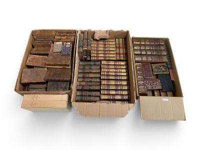 several boxes of old books are stacked on top of each other