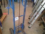 a blue hand truck with a sign on it in a garage