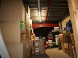 many boxes stacked up in a room with a lot of them