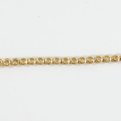 a close up of a gold chain on a white background