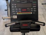 a row of stationary exercise bikes in a gym