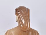 a statue of a man with a hood on a table