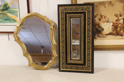 a mirror and a picture frame sitting on a table
