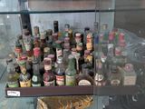 many bottles of alcohol on display in a glass case
