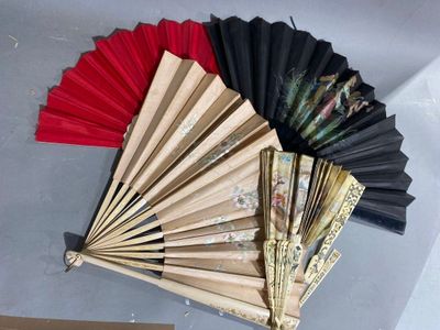 many different colors of paper fans on a table