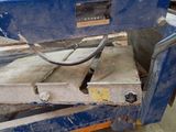 a blue machine that is sitting on a pallet