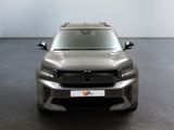 the front view of a silver mercedes suv parked in a room
