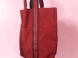a red tote bag on a pink background