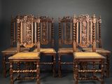 four antique wooden chairs with carved back and seat cushions