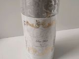 an image of a silver and gold vase on a white table