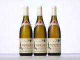 three bottles of wine sitting on top of a table next to each other