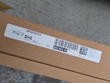 a box with a sticker on it sitting on the floor