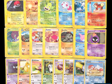 a lot of pokemon cards that are on the table