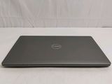 the dell laptop is sitting on a white surface with a white background