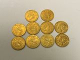 a pile of gold coins sitting on top of a white table
