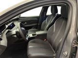 the interior of a car with the door open showing the driver ' s seat area