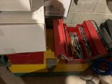 une pile d'outils posée dans une boîte par terre