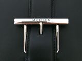 a close up of a black leather bag with a metal buckle