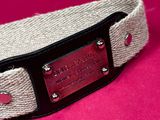 a close up of a dog collar on a pink background