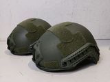 two helmets that are sitting on a table