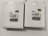 two white boxes with a barcode on them sitting on a table