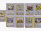 several pokemon cards are lined up on a white surface