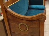 a wooden bench with a blue seat in a store