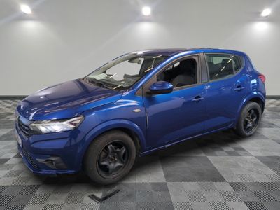 a blue car is parked on a checkered floor in a garage
