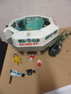 a small toy boat on a table with other toys around it