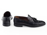 a pair of black leather shoes with tassels on the sole